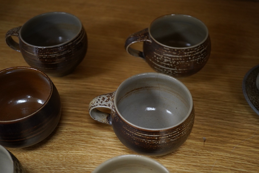 Guy Sydenham (1916-2005), two studio pottery cups and saucers, together with six teacups, incised marks, largest 13.5cm in diameter